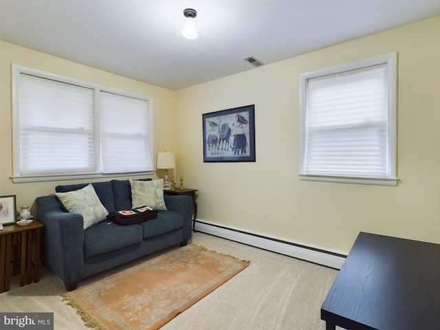 carpeted living room featuring a baseboard heating unit