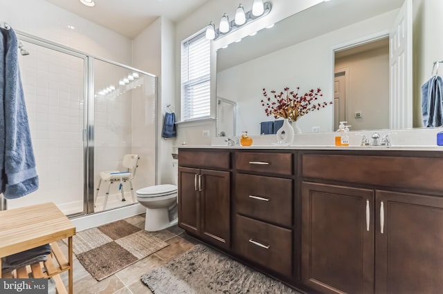 bathroom featuring vanity, an enclosed shower, and toilet