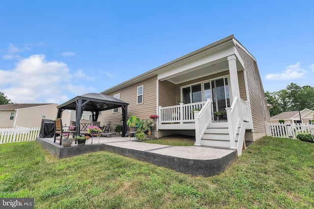 view of front of property with a front lawn, a gazebo, and a patio area