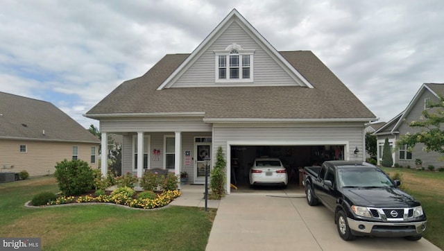 view of front facade with a garage, a front lawn, concrete driveway, and roof with shingles