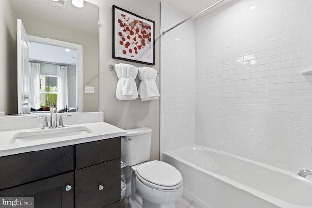 full bathroom featuring toilet, vanity, and tiled shower / bath