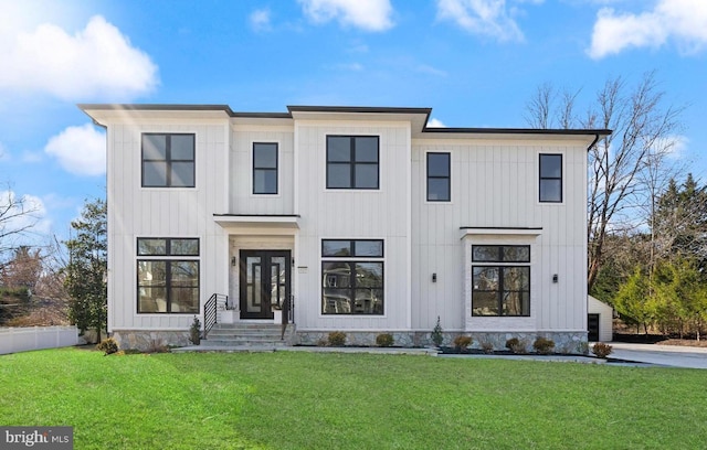 modern inspired farmhouse featuring board and batten siding and a front yard