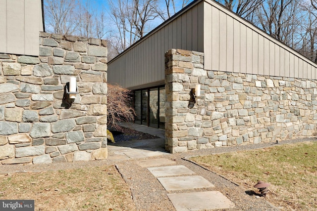 view of side of home featuring stone siding