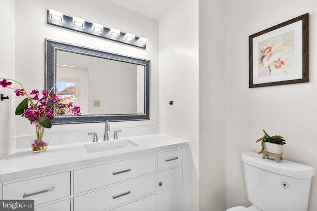 bathroom featuring toilet and vanity