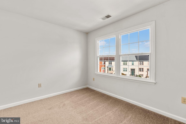 unfurnished room featuring carpet