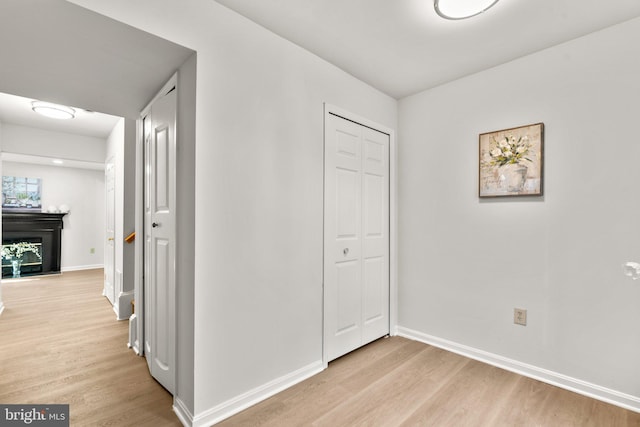 corridor with light hardwood / wood-style floors