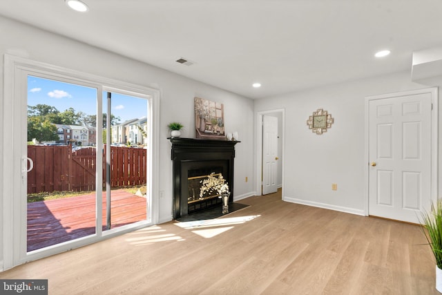 unfurnished living room with light wood-type flooring