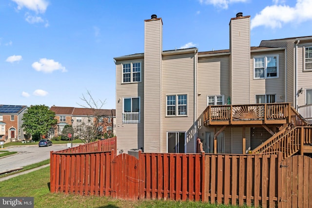 back of property featuring a deck