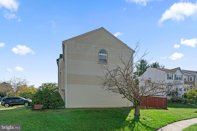 view of home's exterior with a yard