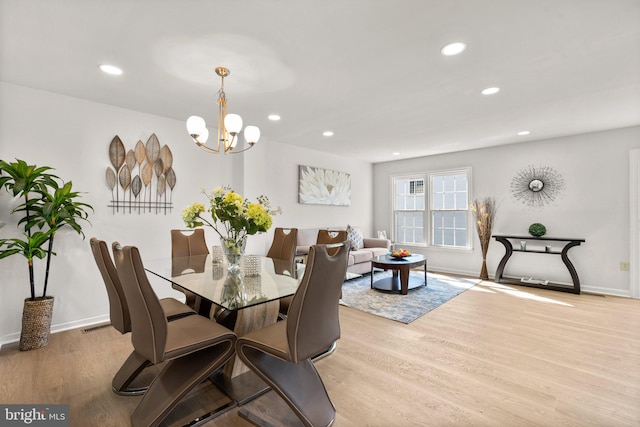 dining space featuring a chandelier and light hardwood / wood-style floors