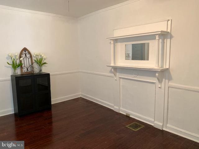 unfurnished dining area featuring dark hardwood / wood-style flooring and ornamental molding