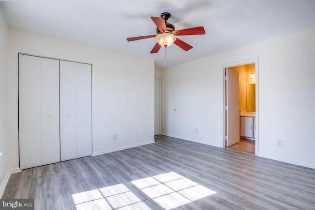 40 Smokewood Ct Unit 200, Stafford, VA 22554 - unfurnished bedroom featuring a ceiling fan, ensuite bath, light wood-style flooring, and baseboards