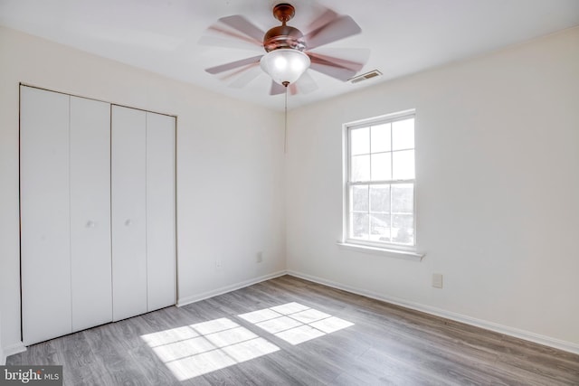 40 Smokewood Ct Unit 200, Stafford, VA 22554 - unfurnished bedroom with light wood finished floors, a closet, visible vents, and baseboards