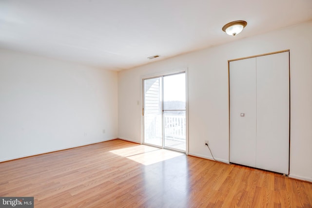 40 Smokewood Ct Unit 200, Stafford, VA 22554 - unfurnished bedroom featuring light wood-type flooring, access to exterior, baseboards, and visible vents