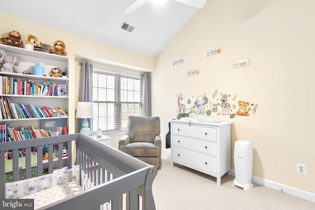 bedroom featuring light colored carpet, visible vents, baseboards, vaulted ceiling, and a crib