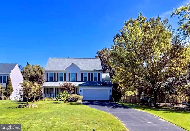 view of front facade with an attached garage, driveway, and a front lawn