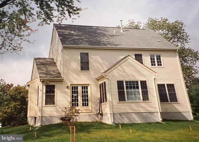 rear view of house featuring a yard