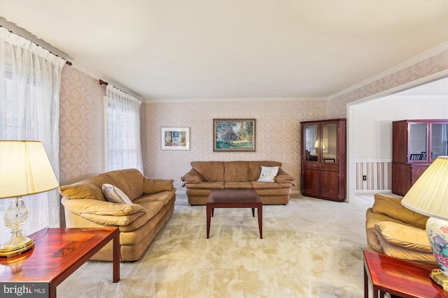 carpeted living area with crown molding and wallpapered walls