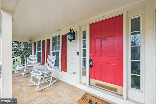 view of exterior entry with a porch