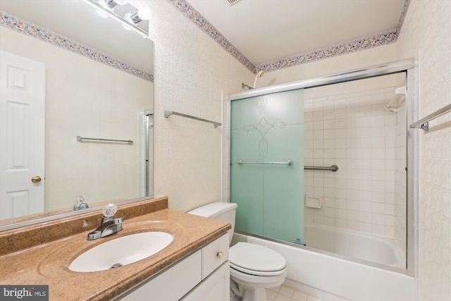 bathroom featuring tile patterned flooring, enclosed tub / shower combo, vanity, and toilet