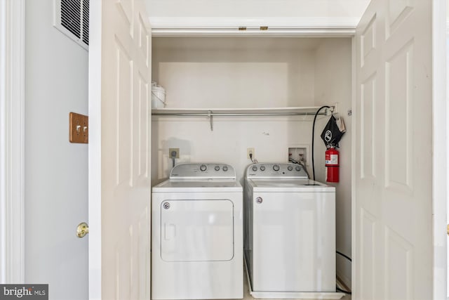 laundry room featuring laundry area, washing machine and dryer, and visible vents
