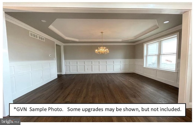 unfurnished dining area with a notable chandelier, ornamental molding, dark hardwood / wood-style flooring, and a raised ceiling