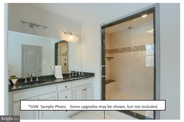 bathroom featuring vanity and a shower with door