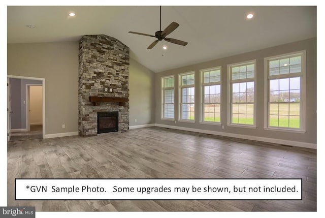 unfurnished living room featuring ceiling fan, high vaulted ceiling, wood-type flooring, and a stone fireplace