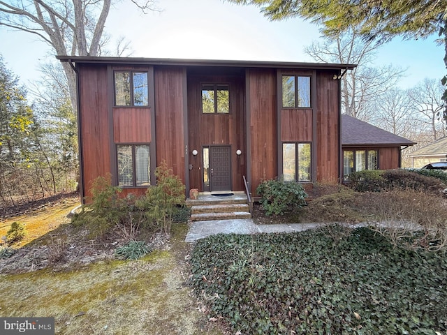 view of front of property featuring roof with shingles