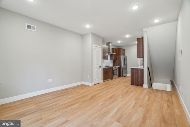 interior space featuring light wood finished floors, baseboards, visible vents, and recessed lighting