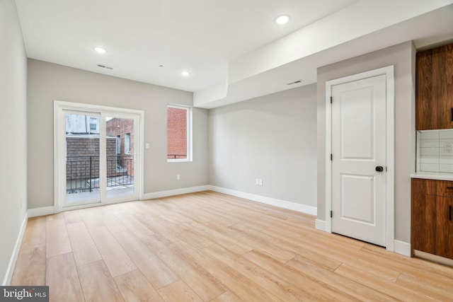 unfurnished room with light wood-style floors, recessed lighting, visible vents, and baseboards