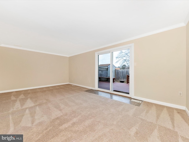 carpeted empty room featuring crown molding