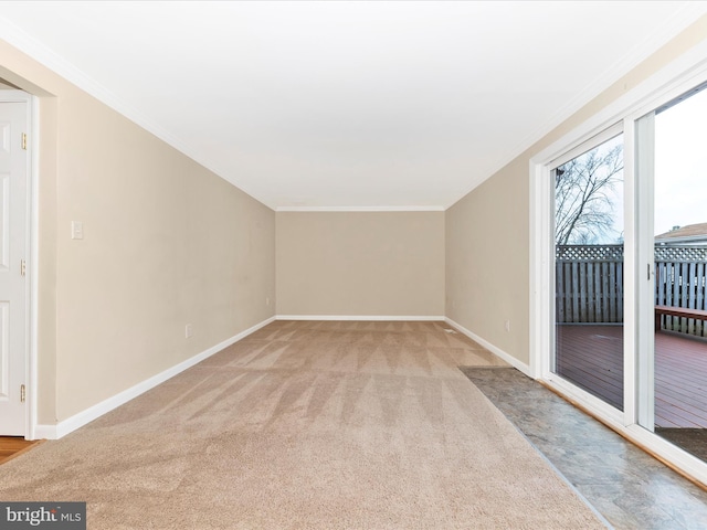 spare room with ornamental molding and light carpet