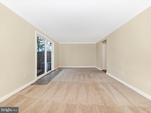 unfurnished room featuring ornamental molding and carpet flooring