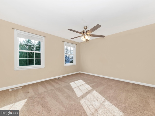 spare room with ceiling fan and carpet flooring