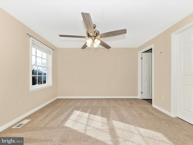 carpeted empty room featuring ceiling fan