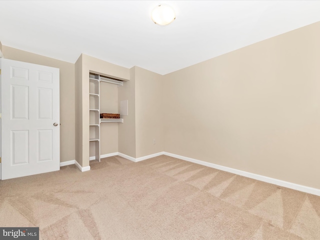 unfurnished bedroom with carpet floors and a closet