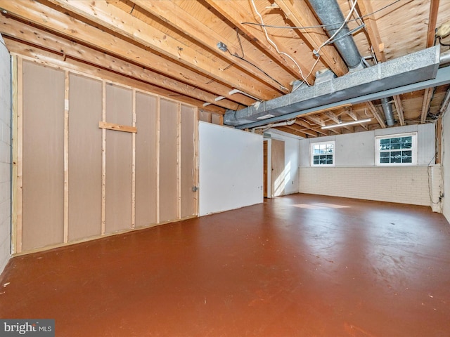 basement featuring brick wall