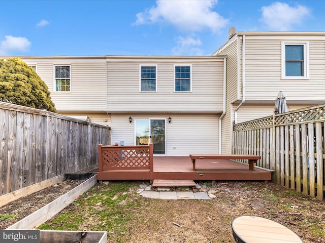 back of property featuring a wooden deck