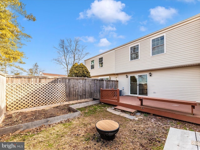 back of house featuring a wooden deck