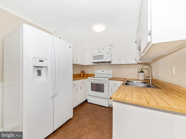 kitchen with sink, white appliances, white cabinetry, and light tile patterned floors