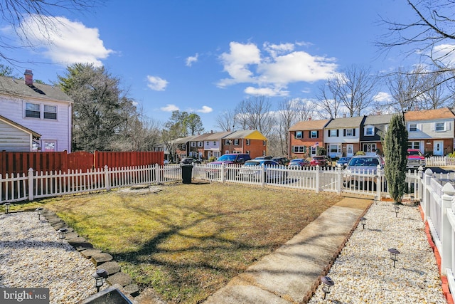 view of yard with a residential view and fence