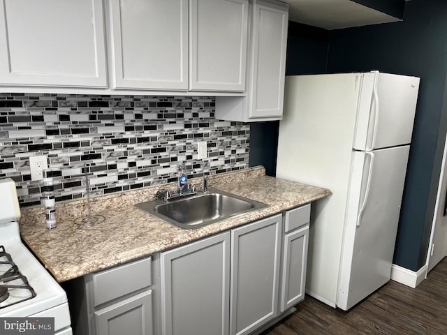 kitchen featuring white cabinetry, dark hardwood / wood-style flooring, sink, backsplash, and white appliances