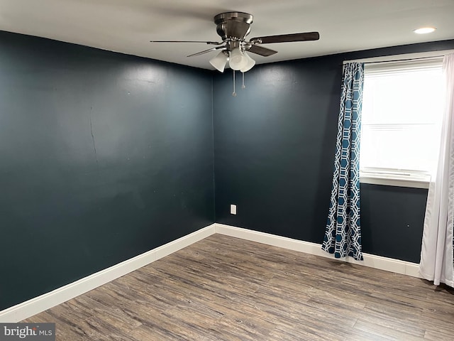 unfurnished room with hardwood / wood-style floors and ceiling fan