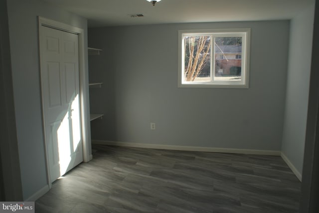 unfurnished bedroom with baseboards, visible vents, and wood finished floors