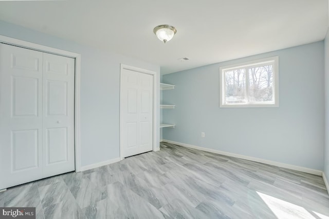 unfurnished bedroom with visible vents and baseboards