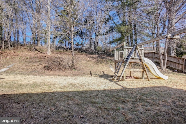 view of yard with fence and a playground