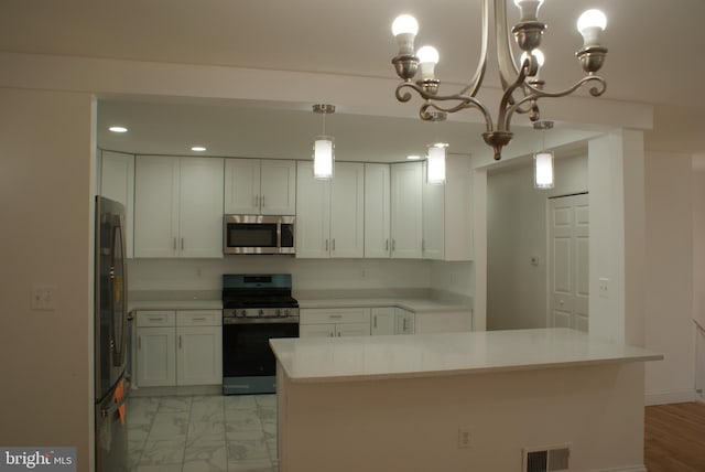 kitchen with stainless steel appliances, light countertops, visible vents, and white cabinetry