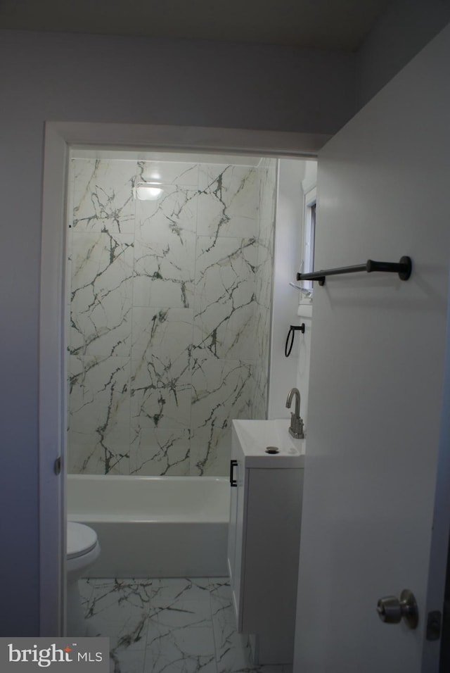 bathroom featuring marble finish floor,  shower combination, vanity, and toilet