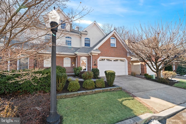 front of property with a front yard and a garage